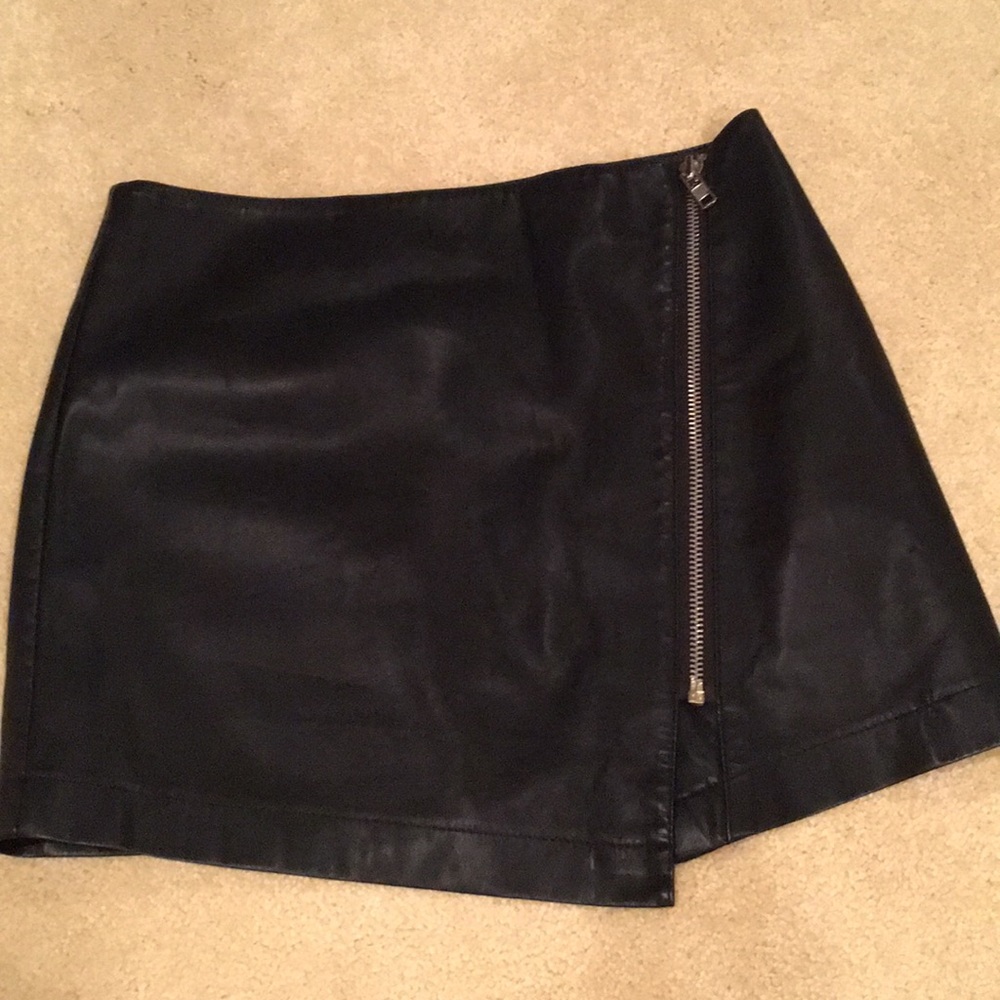 Asymmetrical vegan leather mini skirt.